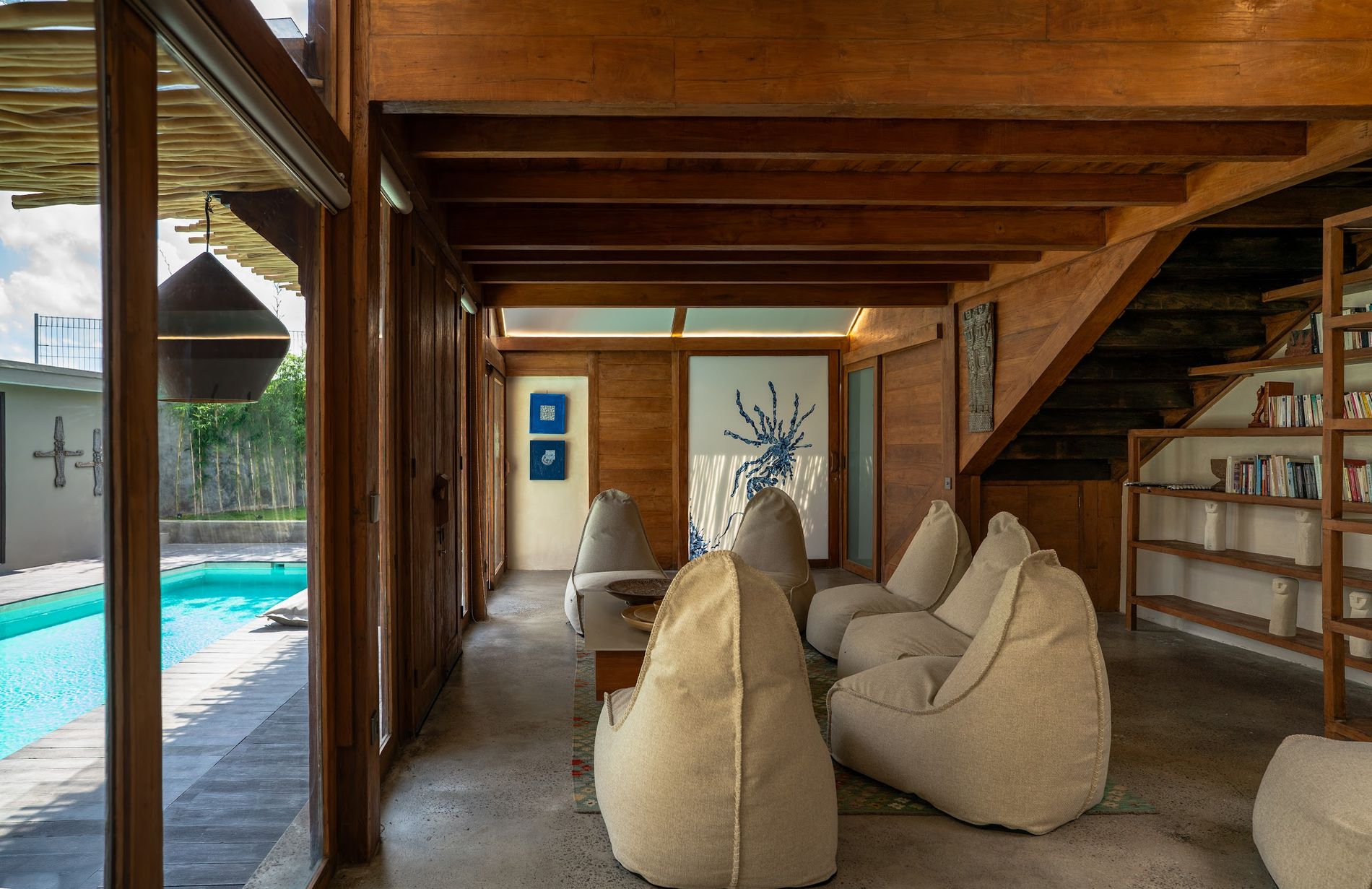 The teak lounge opening straight onto the pool