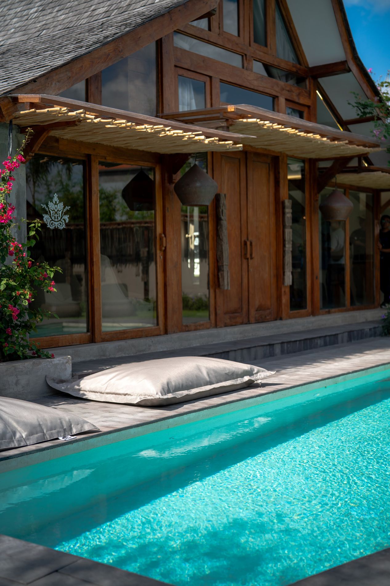 The pool edge beneath the gable